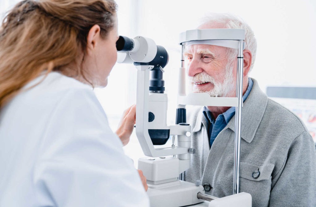 A senior man being examined by an optometrist to detect signs of glaucoma.