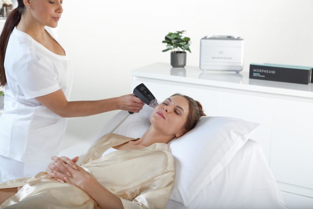A woman laying down at an aesthetics clinic receiving Morpheus8 Treatment.