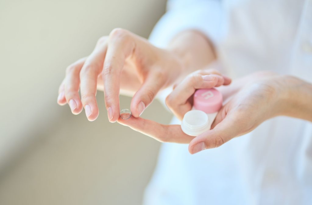 Person holding a contact lens and its case.