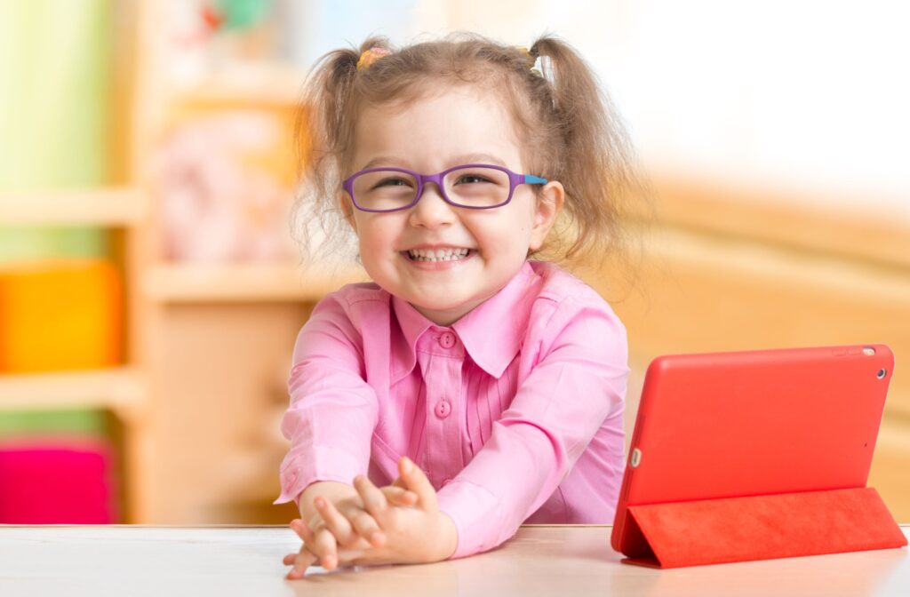 School-age girl in glasses reading a book, illustrating eye-friendly habits during homework.