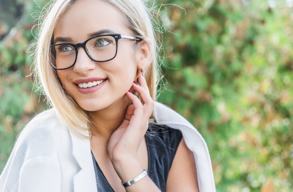 Young adult woman outside wearing glasses.