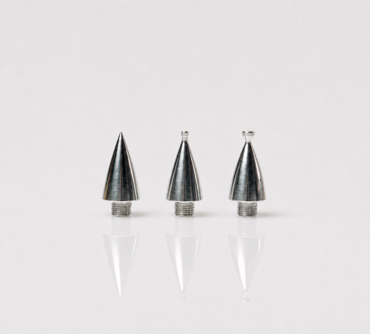 Three silver Jett Plasma Pen tips displayed upright on a clean reflective surface, showing different tapered metal applicator shapes with threaded bases.